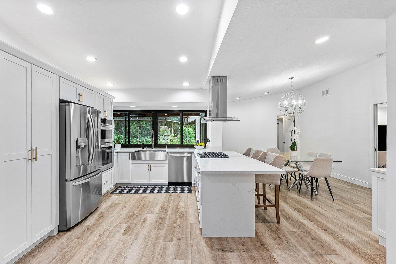 2425 Northwest 36th Street Boca Raton, FL 33431 - Photo 8 of 31 a large kitchen with a table and chairs