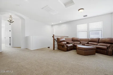 a bedroom with furniture and a bed next to a window
