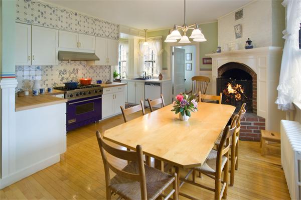 51 Upland Road Brookline, MA 02445 - Photo 6 of 14 a dining table with chairs and kitchen view