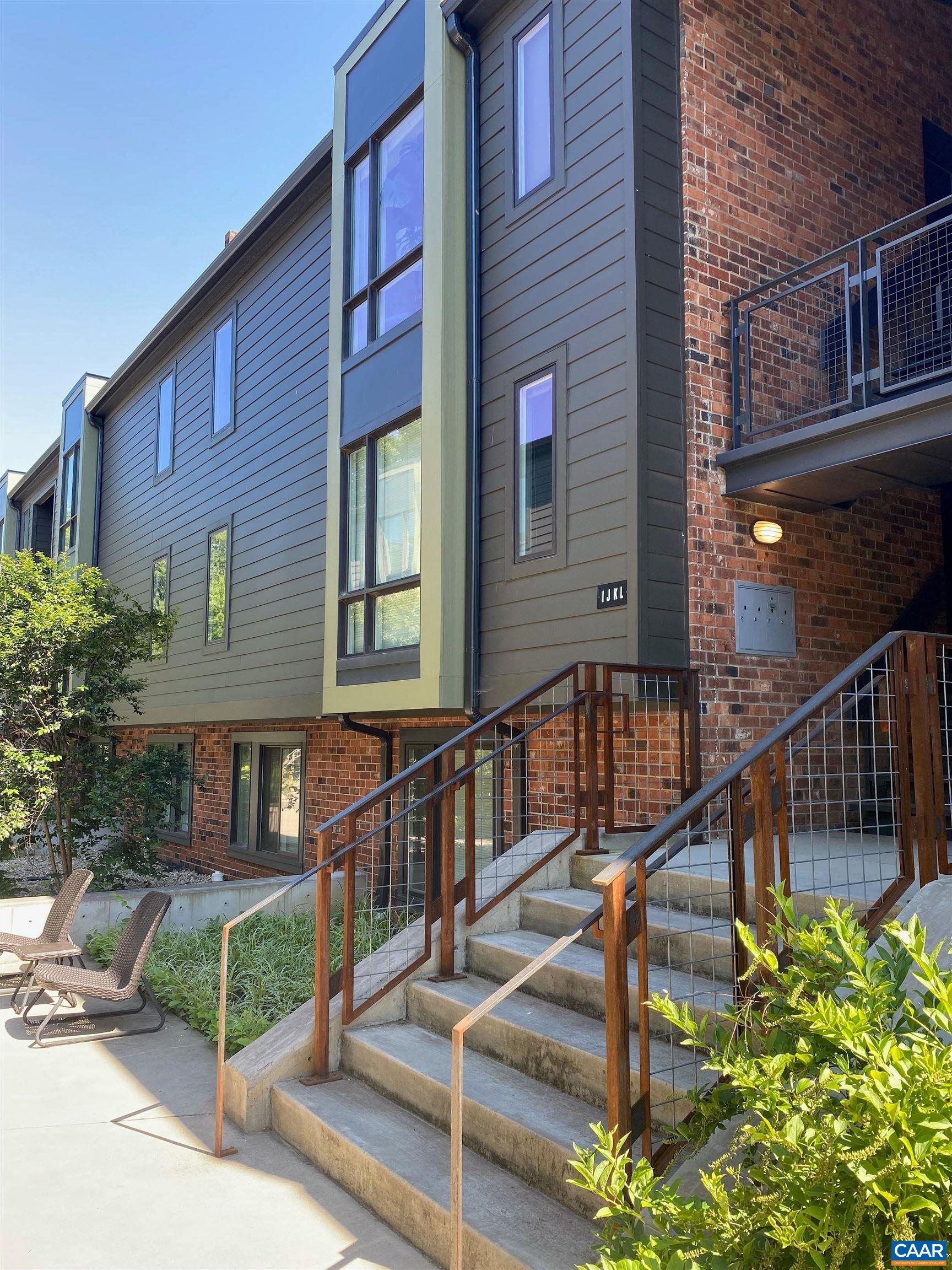 630 Park Street, Unit R Charlottesville, VA 22902 - Photo 1 of 10 a view of a house with wooden stairs and a small yard