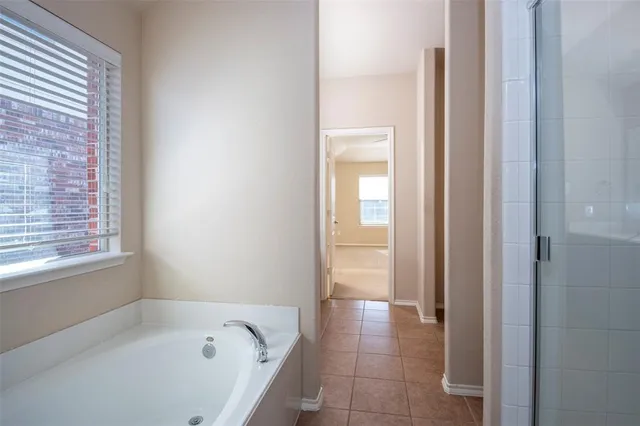 a bathroom with a bathtub and a window