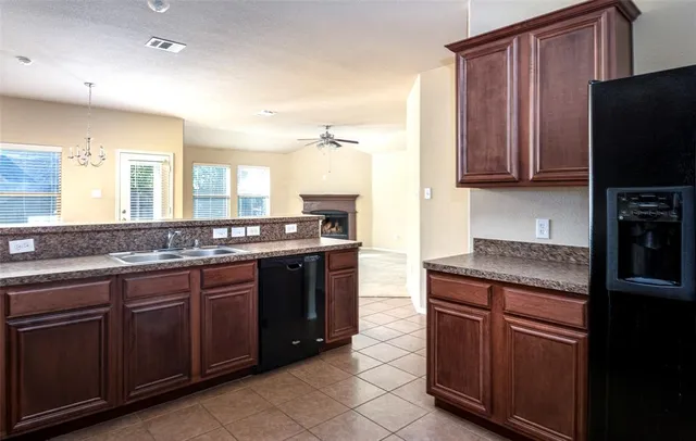 a kitchen with granite countertop stainless steel appliances and wooden cabinets