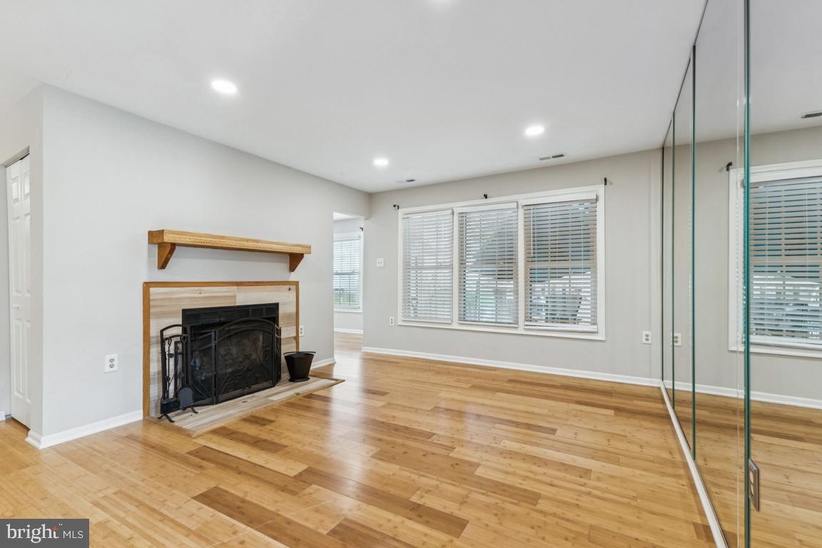 7402 Rokeby Drive Manassas, VA 20109 - Photo 3 of 25 Spacious living area anchored by a cozy fireplace