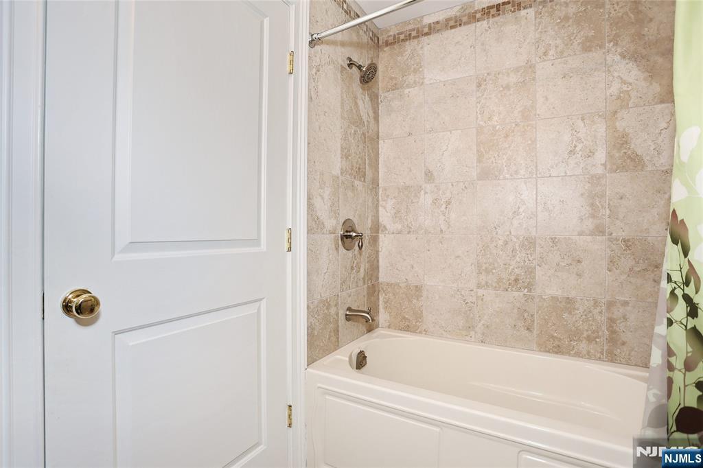 65 Ross Avenue Demarest, NJ 07627 - Photo 43 of 48 a bathroom with a tub shower and a sink
