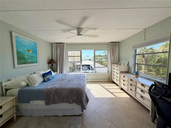 a spacious bedroom with a large bed and a large window