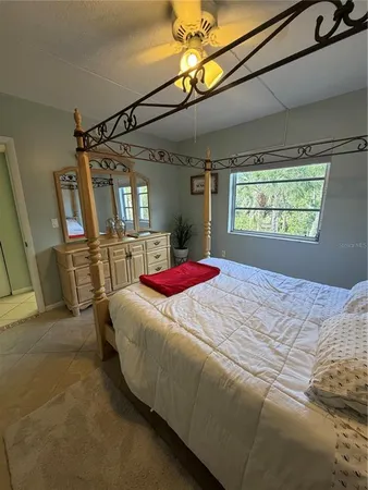 a bathroom with a sink a toilet a window and tub