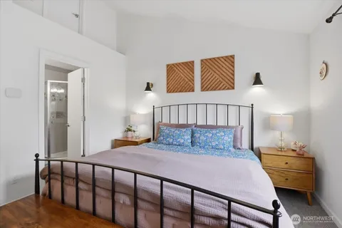 a bedroom with a bed and wooden floor