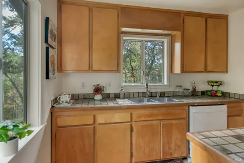 a kitchen with a sink cabinets and window