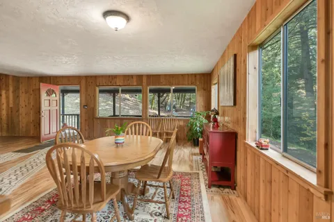 a dining room with furniture wooden floor and a rug