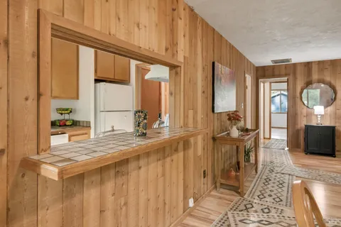 a spacious bathroom with a granite countertop sink and a mirror