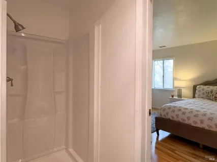 a bedroom with a bed and a mirror