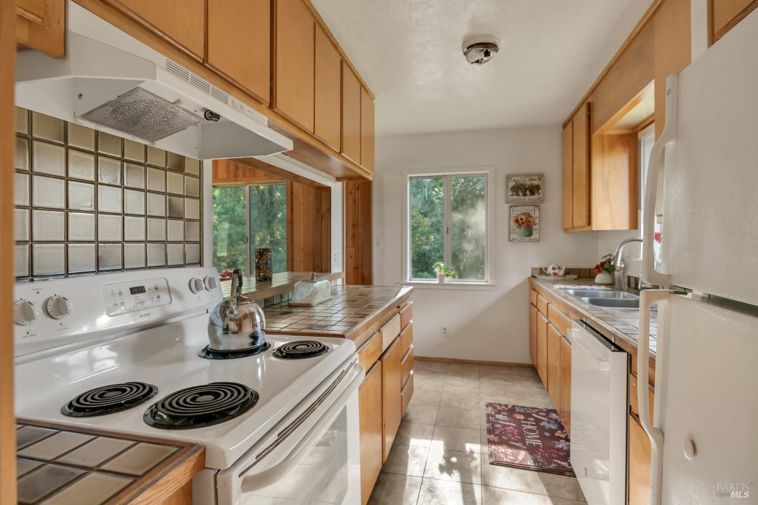 3100 Mill Creek Road Healdsburg, CA 95448 - Photo 9 of 41 a kitchen with a stove a sink and a refrigerator