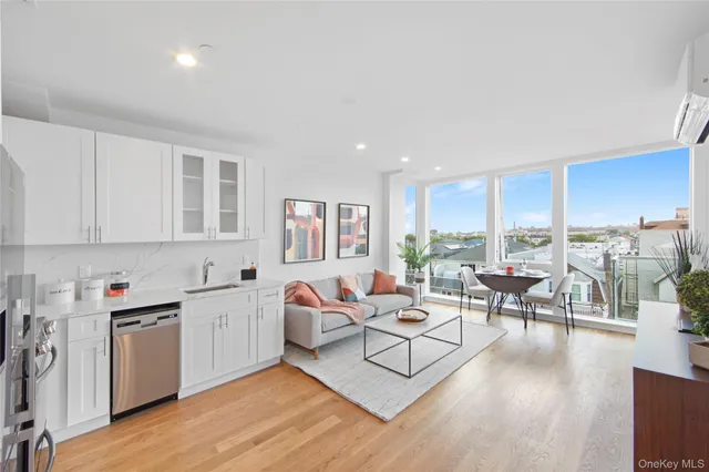 a living room with furniture floor to ceiling window and wooden floor
