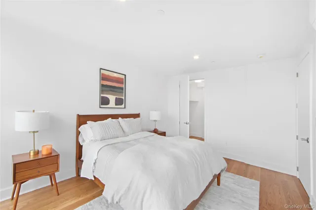 a bedroom with a bed and a lamp