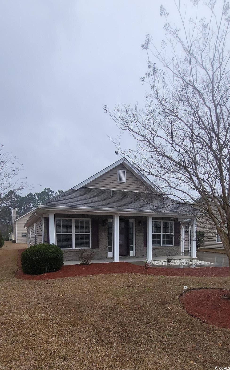 View of front of home featuring a porch and a front lawn