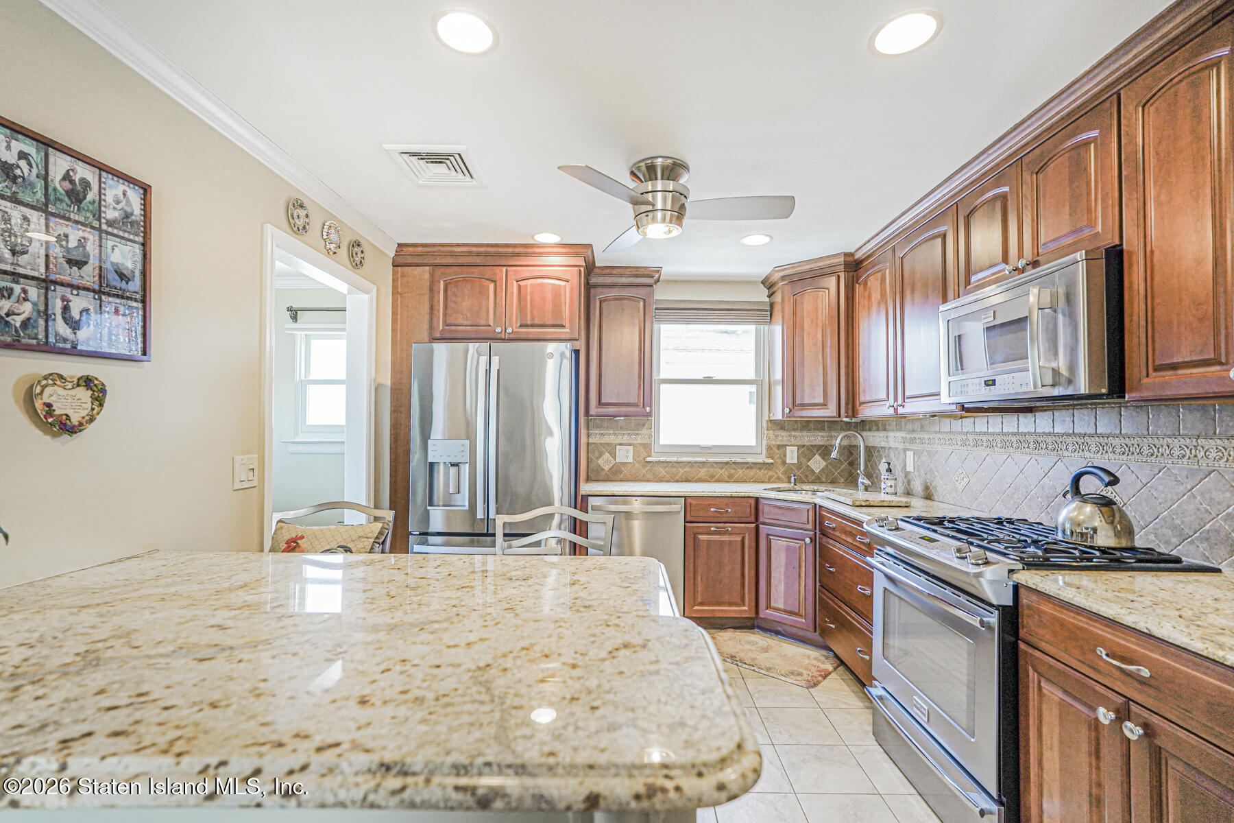76 Berry Avenue Staten Island, NY 10312 - Photo 10 of 42 a large kitchen with kitchen island granite countertop a sink cabinets and window