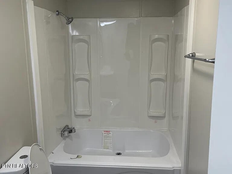 1399 Whites Creek Road Spring City, TN 37381 - Photo 4 of 8 a white bath tub sitting next to a white sink and vanity