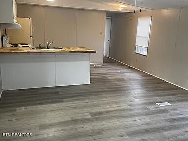1399 Whites Creek Road Spring City, TN 37381 - Photo 5 of 8 a view of a kitchen with wooden floor and window