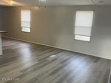1399 Whites Creek Road Spring City, TN 37381 - Photo 7 of 8 an empty room with wooden floor and windows
