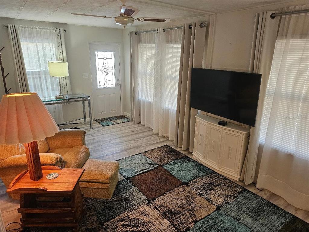 5619 Bayshore Road, Unit 115 Palmetto, FL 34221 - Photo 3 of 21 a living room with furniture and a flat screen tv