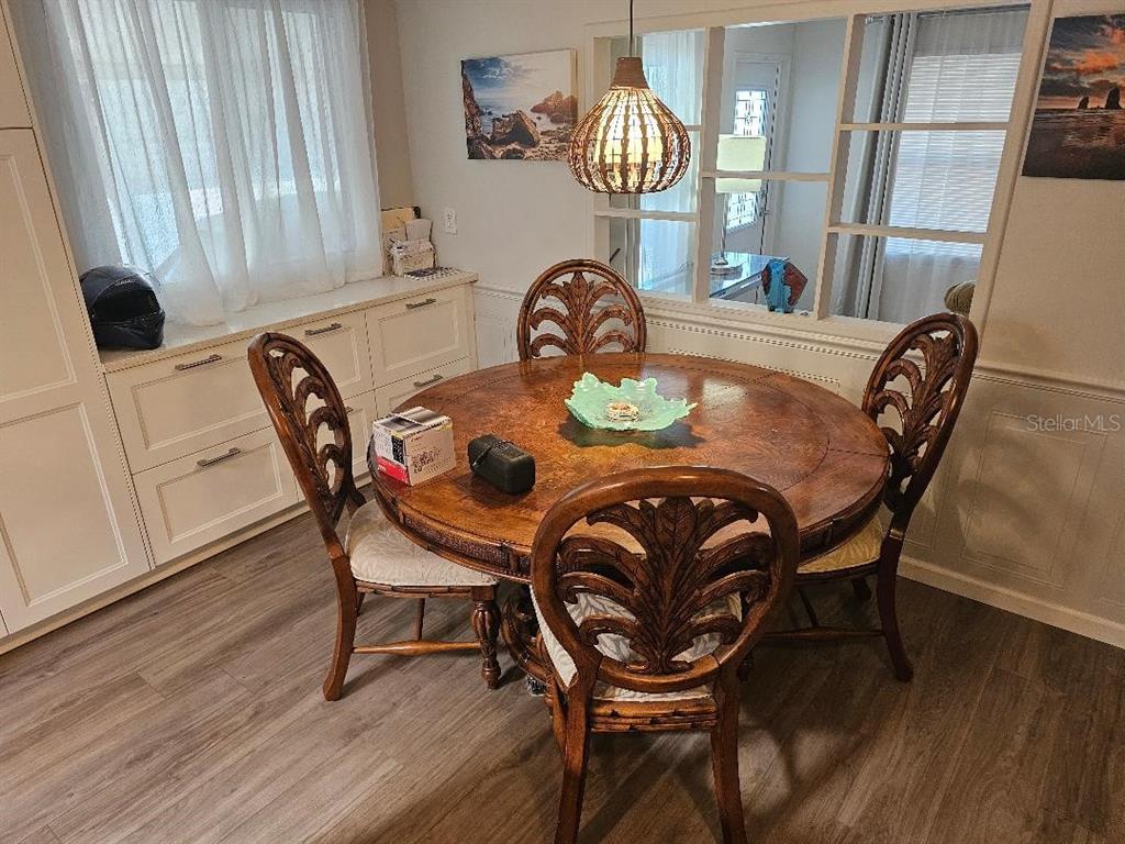 5619 Bayshore Road, Unit 115 Palmetto, FL 34221 - Photo 5 of 21 a view of a dining room with furniture and wooden floor