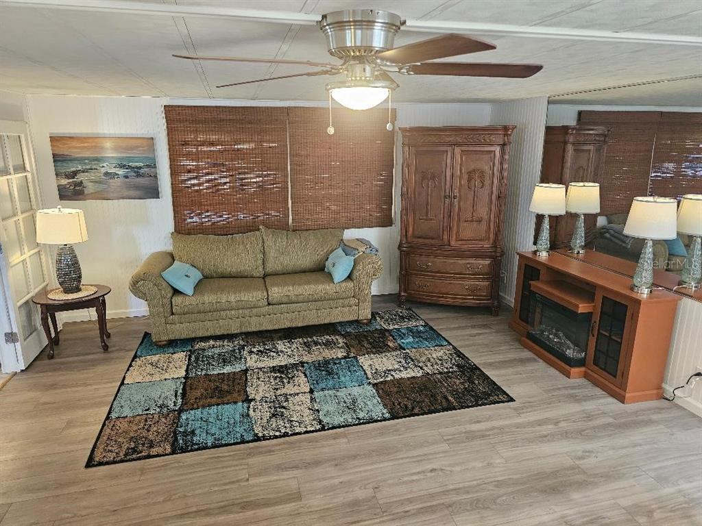 5619 Bayshore Road, Unit 115 Palmetto, FL 34221 - Photo 6 of 21 a living room with furniture and a fireplace