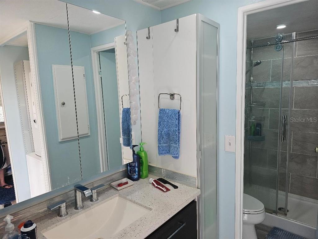5619 Bayshore Road, Unit 115 Palmetto, FL 34221 - Photo 8 of 21 a bathroom with a sink a toilet and shower