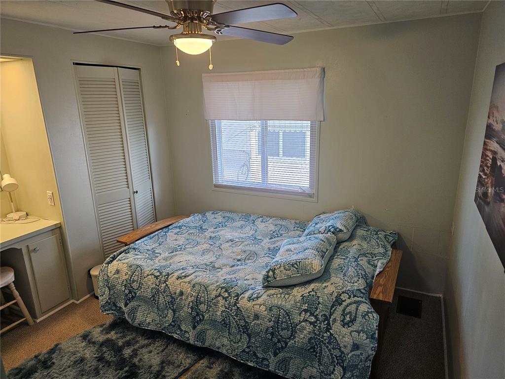 5619 Bayshore Road, Unit 115 Palmetto, FL 34221 - Photo 10 of 21 a bedroom with a bed and a window