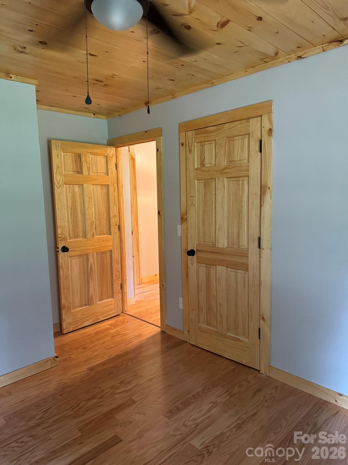 893 Carnes Road Franklin, NC 28734 - Photo 22 of 28 a view of an empty room with wooden floor and a window