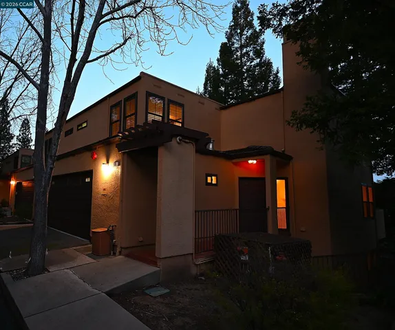a front view of a house with plants