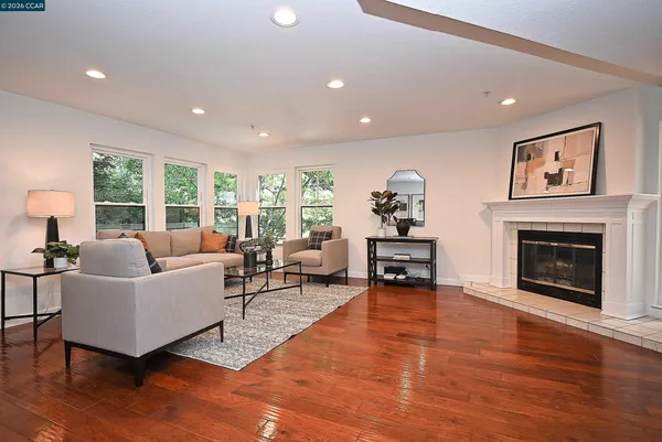 a kitchen with stainless steel appliances granite countertop a lot of cabinets a stove and wooden floor