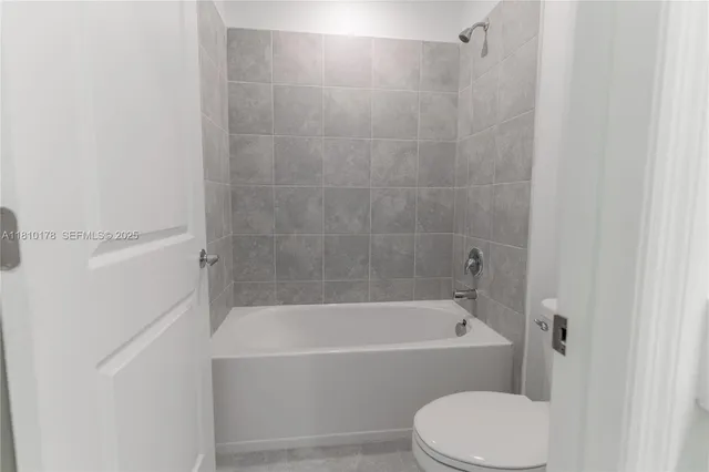 a bathroom with a bathtub and a toilet