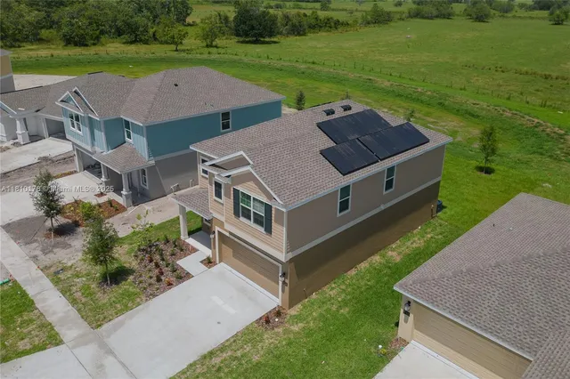 a aerial view of a house with a yard