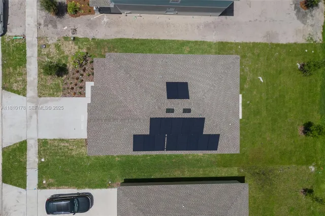 a aerial view of a house with a yard
