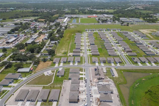 an aerial view of residential houses with outdoor space and river