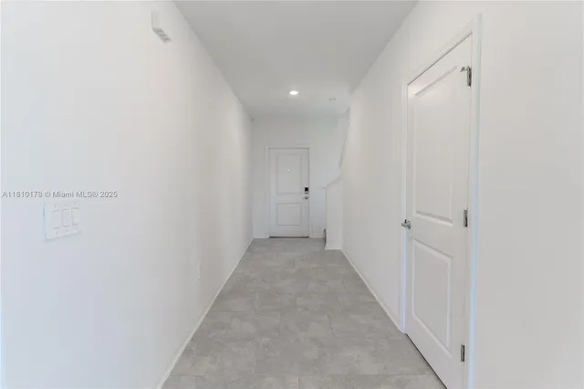 a view of a kitchen with a sink and a refrigerator