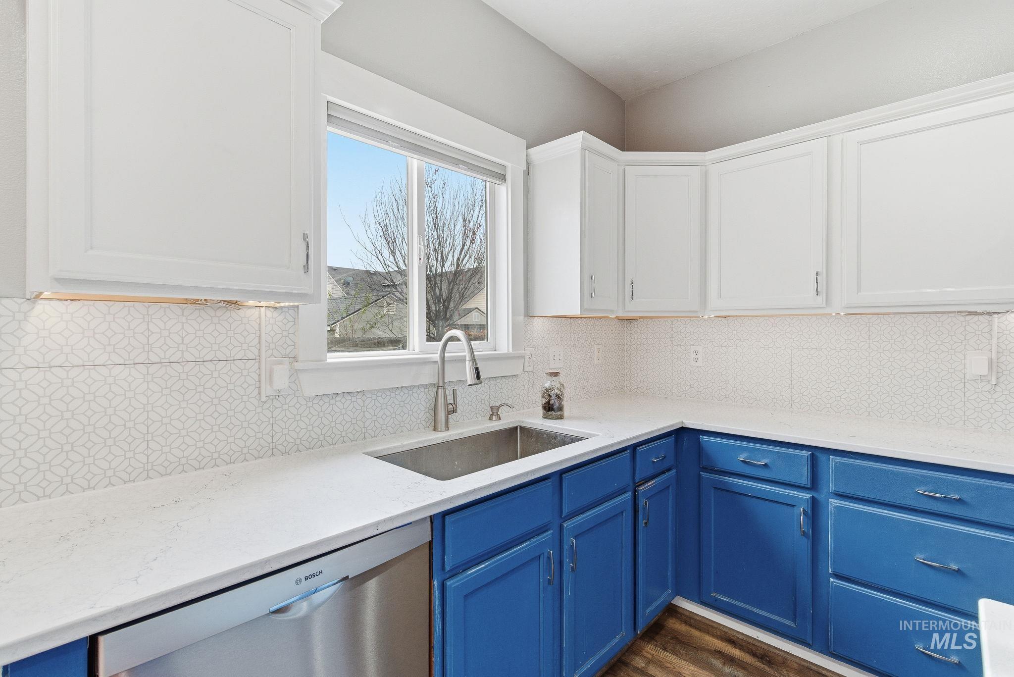2520 Summercrest Street Caldwell, ID 83607 - Photo 12 of 42 Kitchen featuring blue cabinets, dishwasher, white cabinets, and light stone countertops