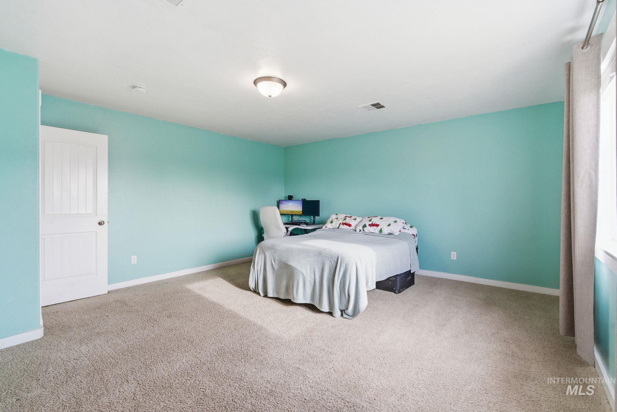 2520 Summercrest Street Caldwell, ID 83607 - Photo 28 of 42 Bedroom featuring light colored carpet and baseboards