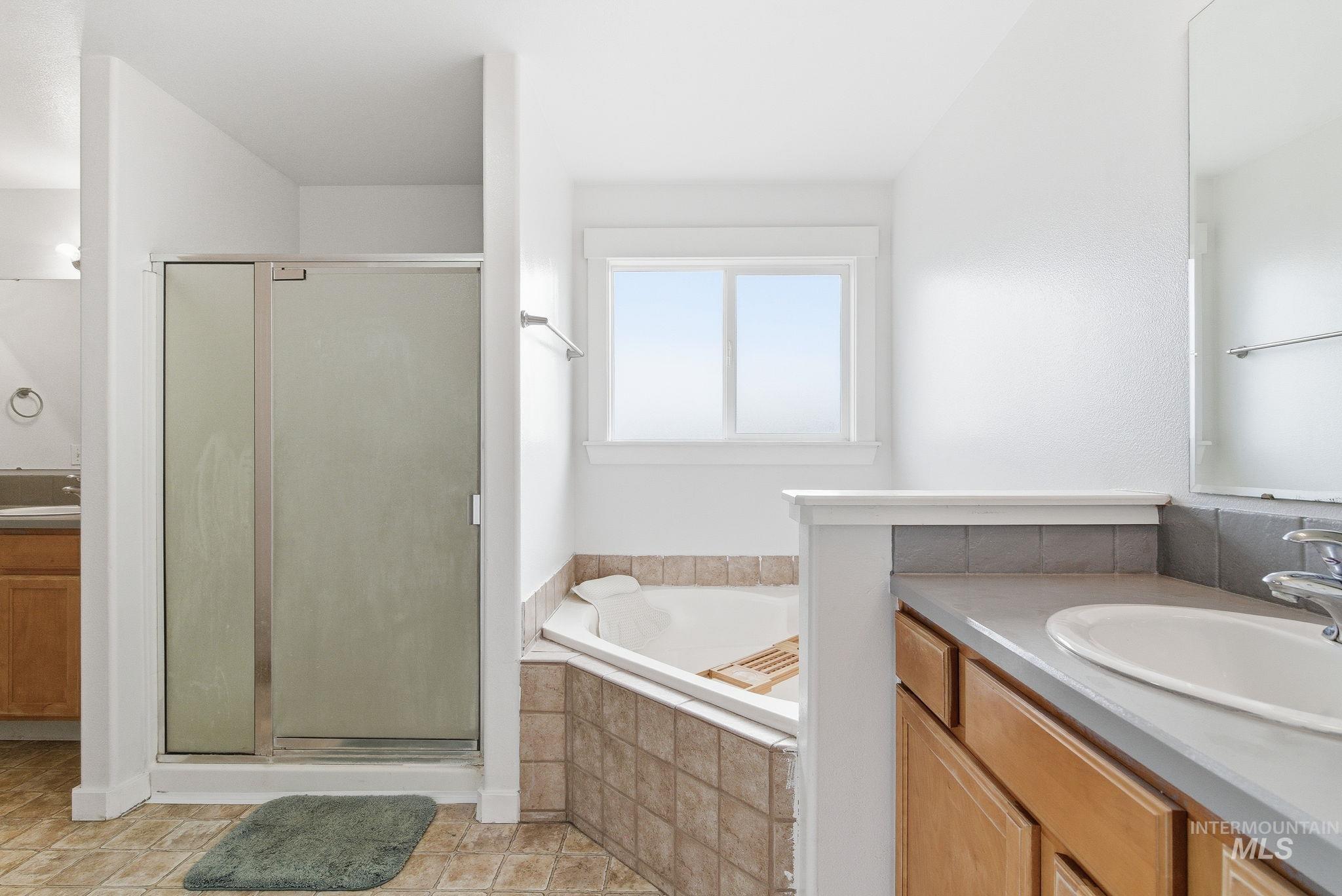 2520 Summercrest Street Caldwell, ID 83607 - Photo 35 of 42 Bathroom with vanity, a stall shower, and a bath