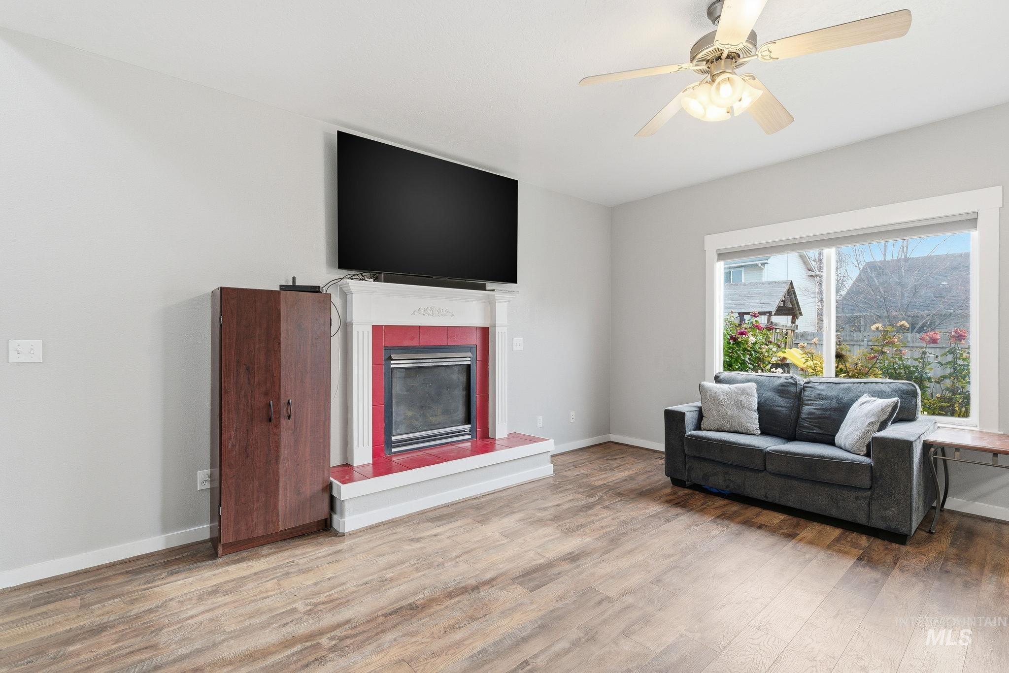 2520 Summercrest Street Caldwell, ID 83607 - Photo 4 of 42 Living room with a fireplace, wood finished floors, and a ceiling fan