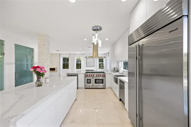 a large white kitchen with a large window