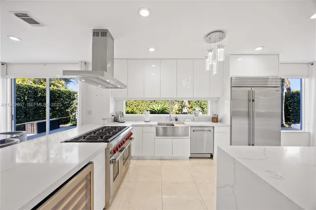 a kitchen with stainless steel appliances a large window in it