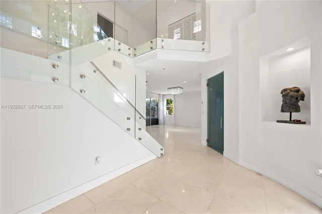 view of a hallway with wooden floor and a bathroom
