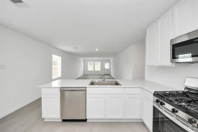 a kitchen that has a sink and a stove