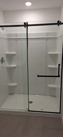 a bathroom with a toilet and a shower