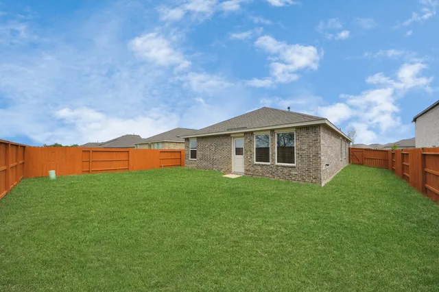 a view of yard with swimming pool and seating area