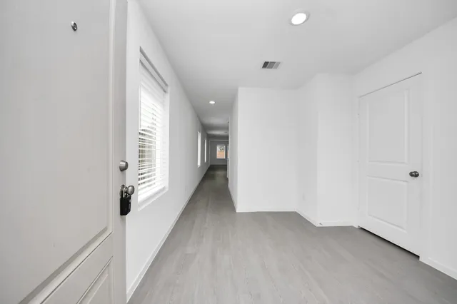 a view of hallway with wooden floor