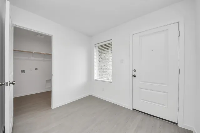a view of an empty room with a closet