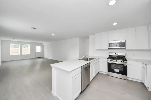 a kitchen with a stove a sink and a refrigerator