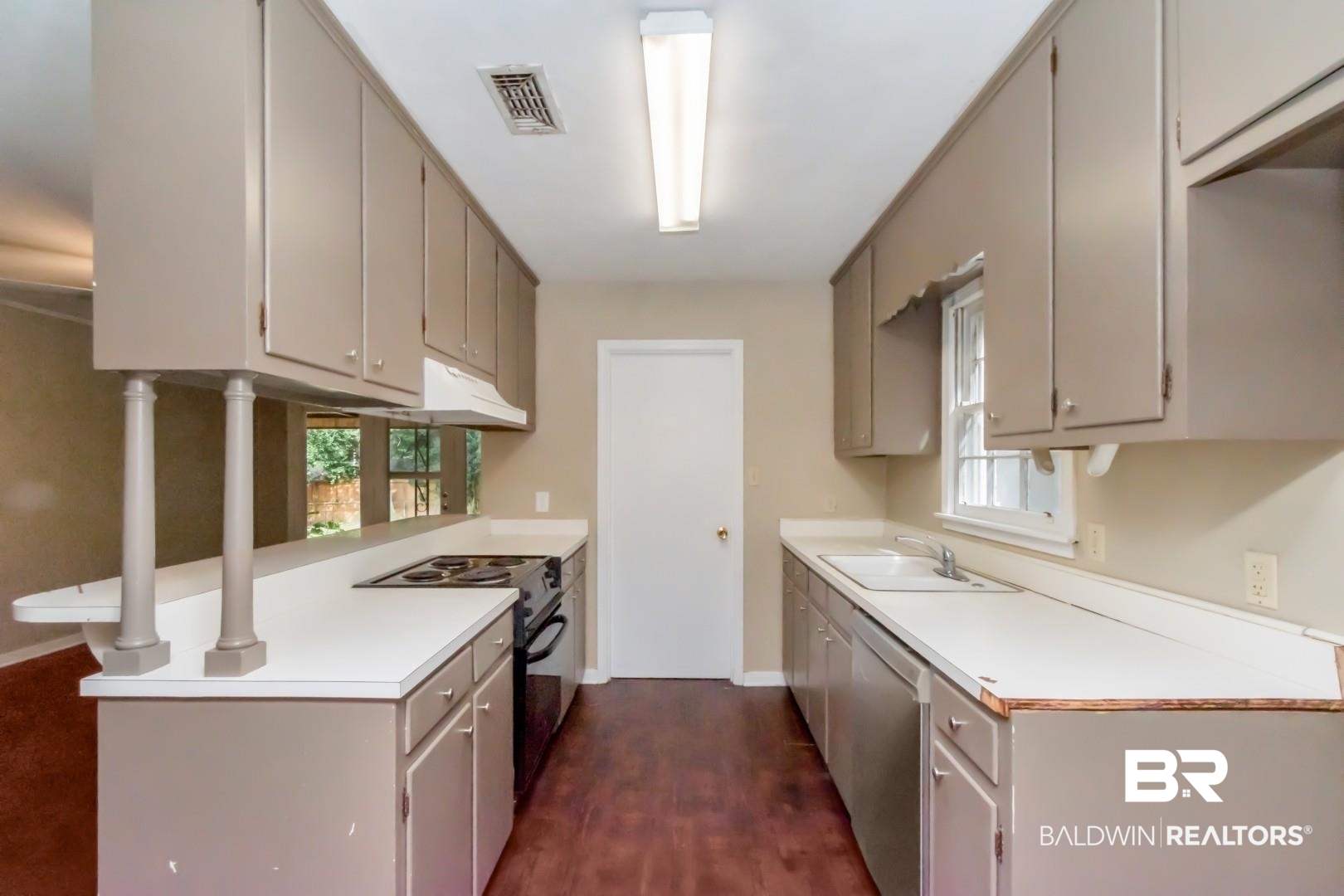 324 Judson Drive Mobile, AL 36608 - Photo 6 of 20 Kitchen with electric range, a peninsula, light countertops, stainless steel dishwasher, and dark wood-type flooring